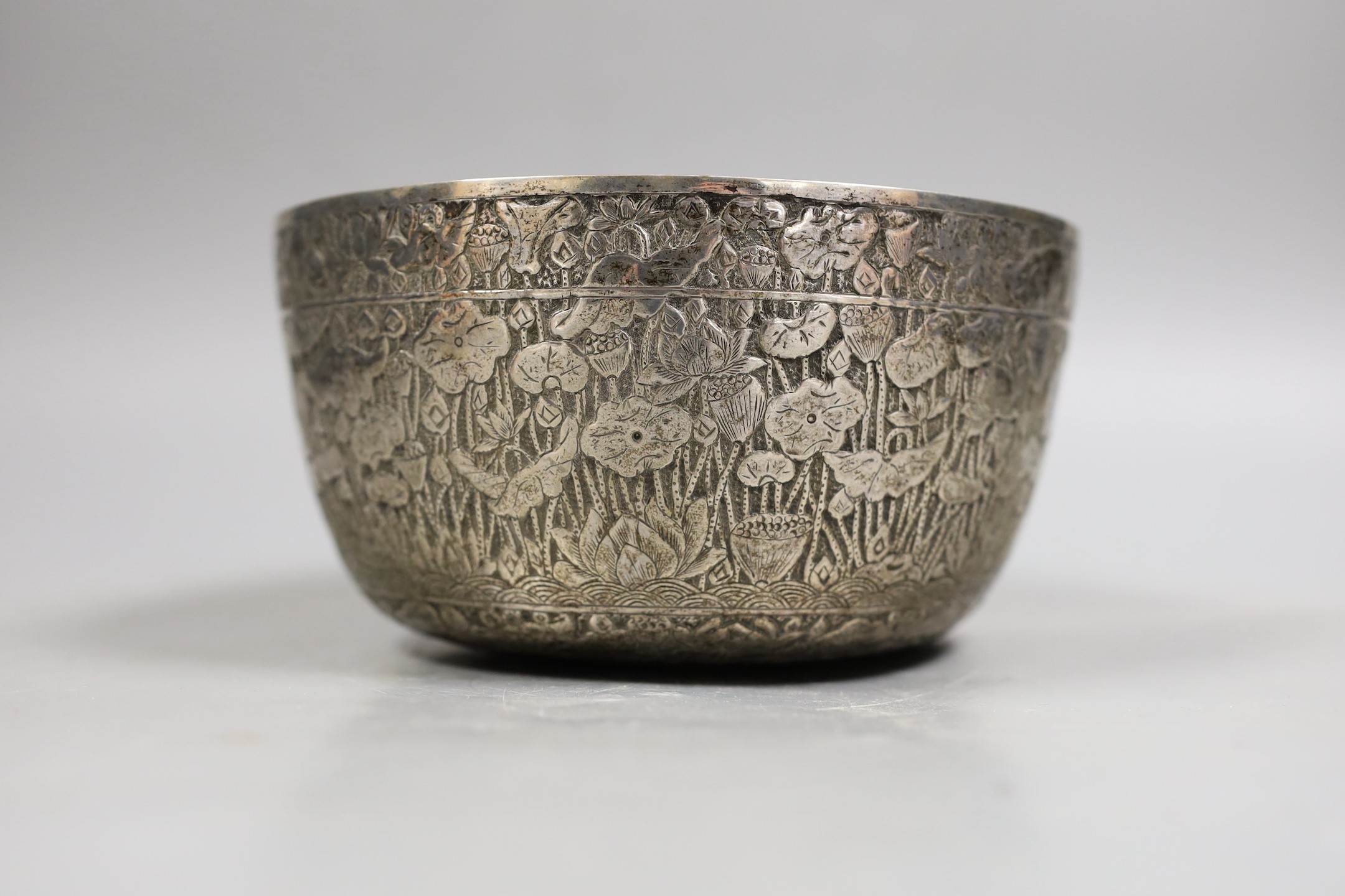 An Eastern embossed white metal bowl, diameter 17.7cm, 9.4oz.